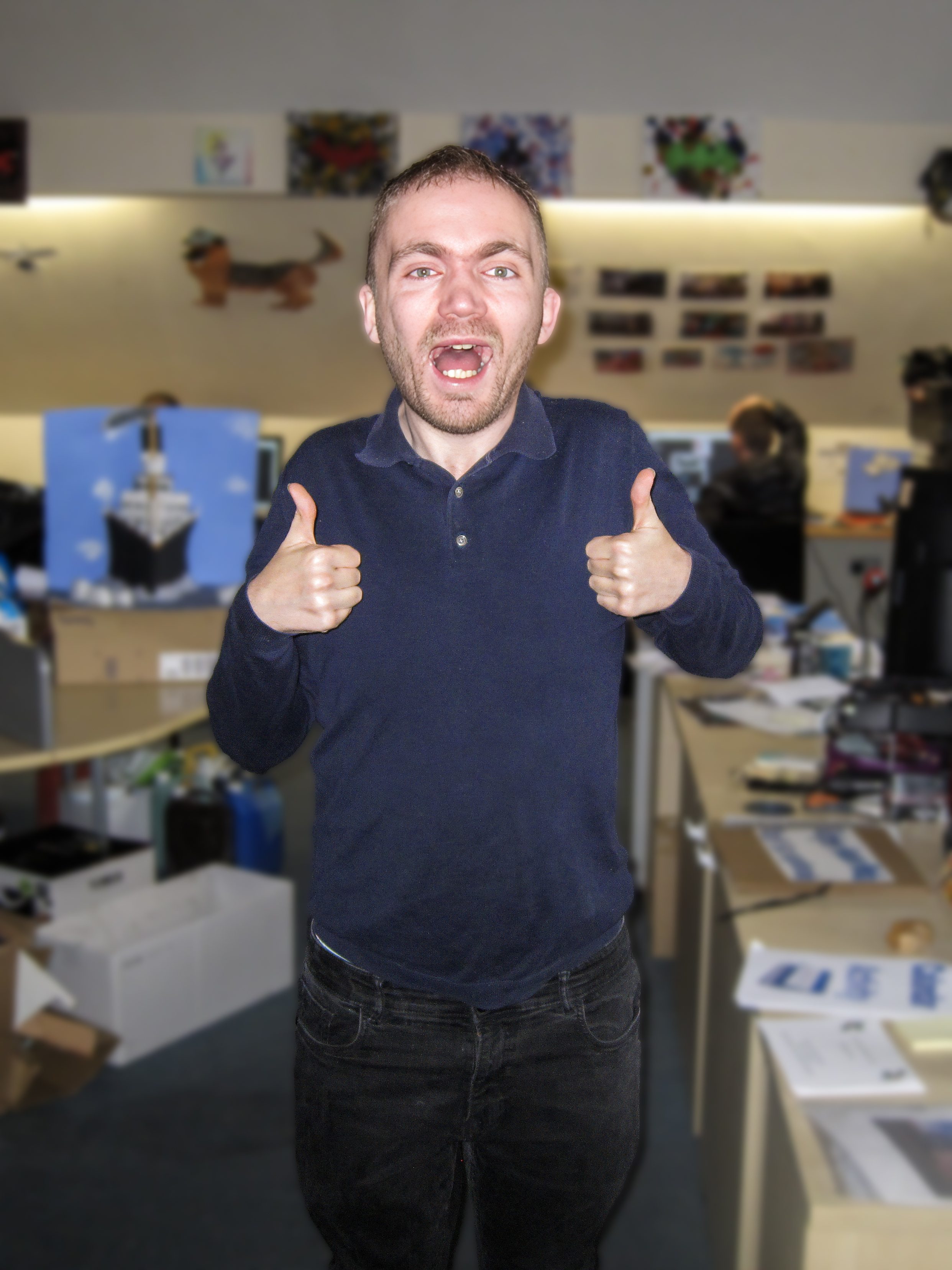 Person in blue shirt giving two thumbs up